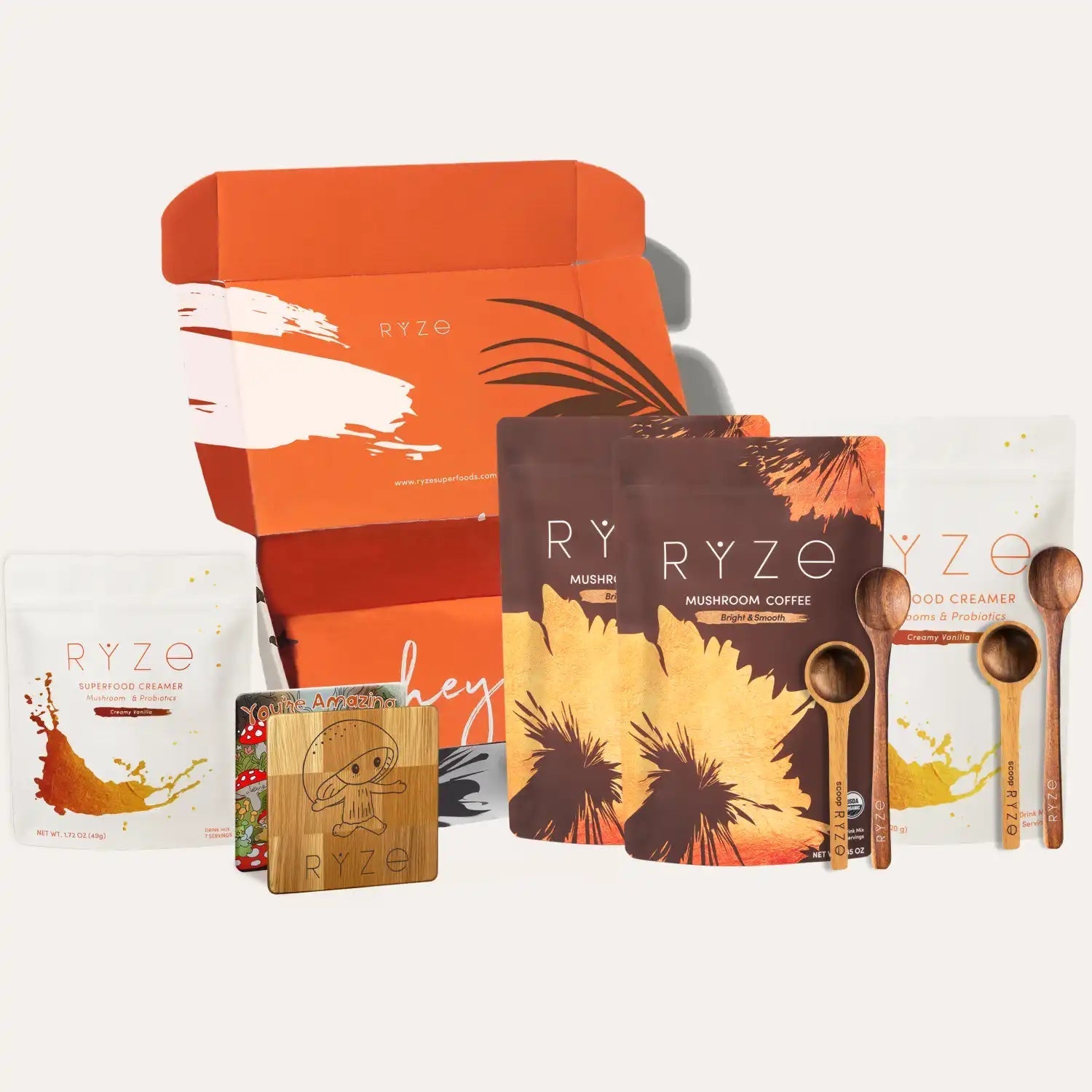 Collection of RYZE products including a box, coffee package, and wooden items on a white background